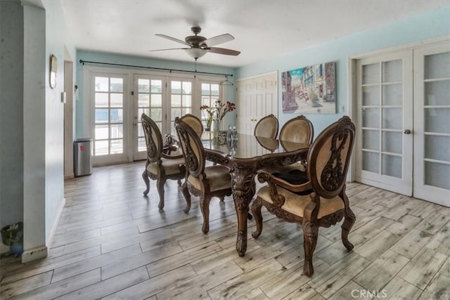 dining space featuring french doors, light wood-type flooring, and ceiling fan