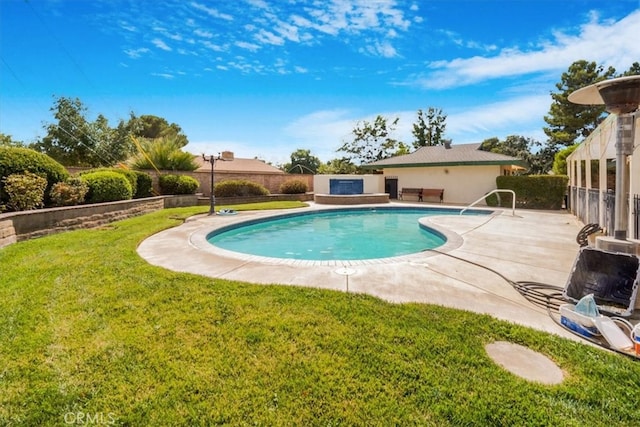 view of swimming pool featuring a yard and a patio area