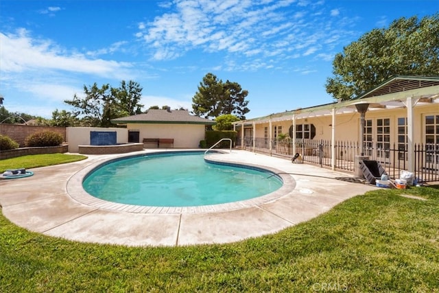 view of pool featuring a patio area and a yard