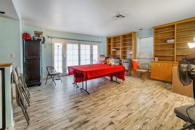 playroom with light hardwood / wood-style flooring and french doors