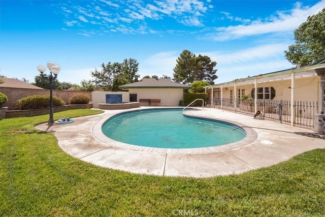 view of pool with a patio and a yard