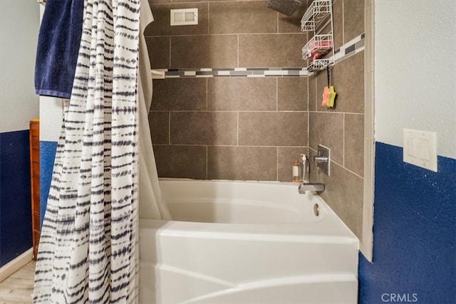 bathroom featuring hardwood / wood-style flooring and shower / bath combo