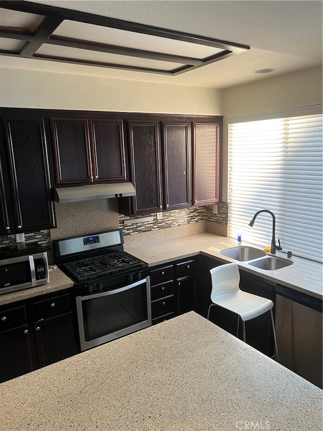 kitchen featuring sink, backsplash, and appliances with stainless steel finishes