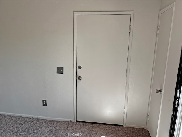 doorway featuring light colored carpet