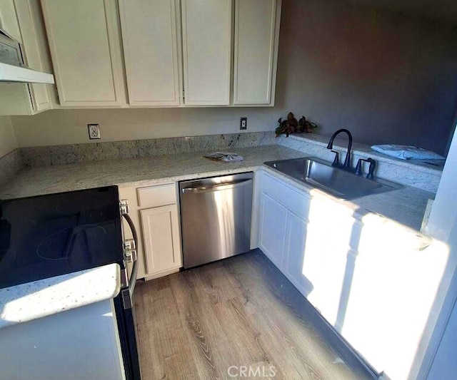 kitchen featuring light hardwood / wood-style floors, sink, white cabinets, black range oven, and stainless steel dishwasher