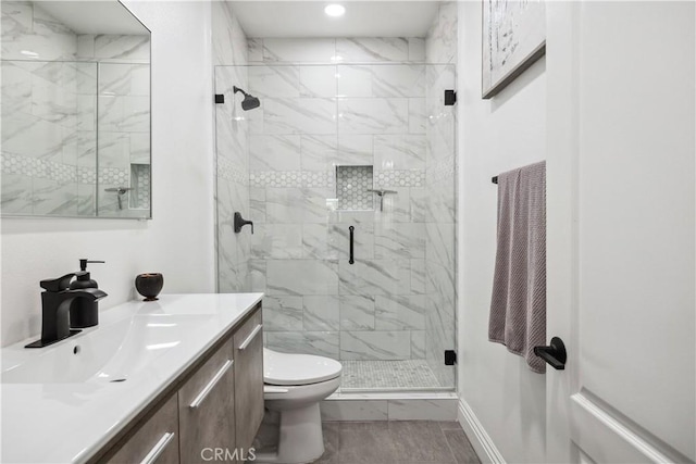 bathroom featuring walk in shower, vanity, and toilet