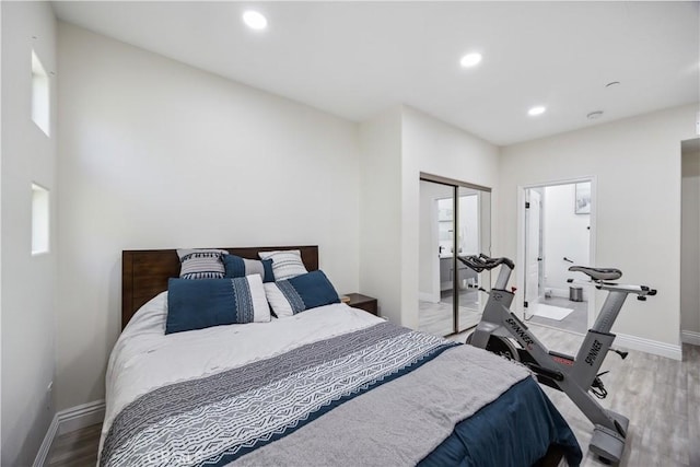 bedroom with light wood-type flooring and a closet