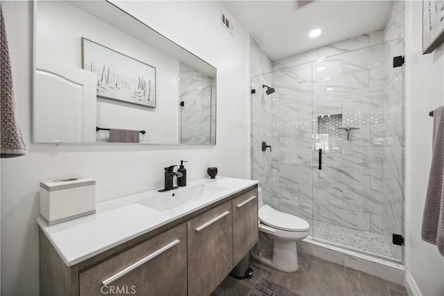 bathroom featuring vanity, an enclosed shower, and toilet