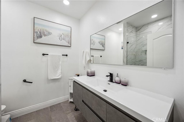 bathroom with vanity and a tile shower