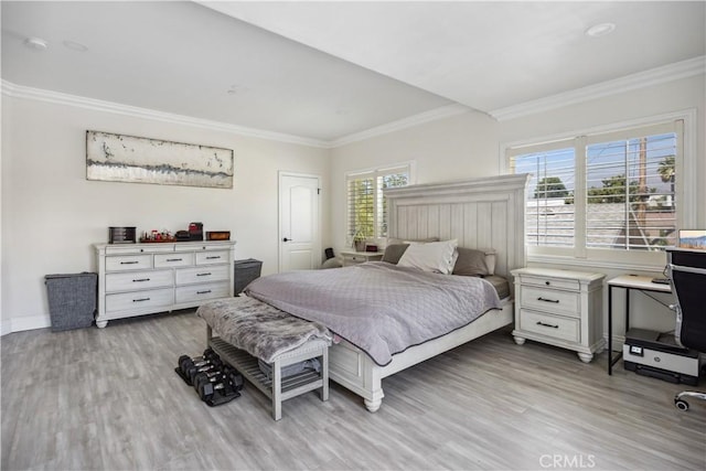 bedroom with crown molding and light wood-type flooring