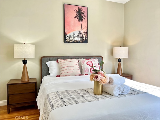 bedroom with wood-type flooring