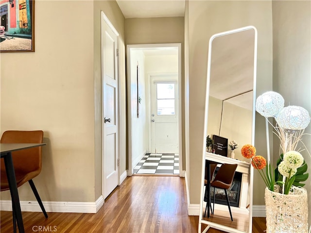 hall with hardwood / wood-style flooring