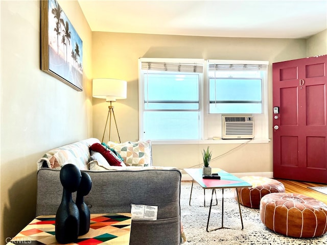 living room with cooling unit and hardwood / wood-style flooring