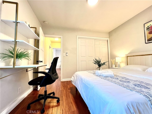 bedroom featuring a closet and dark hardwood / wood-style floors