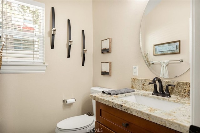 bathroom with vanity and toilet