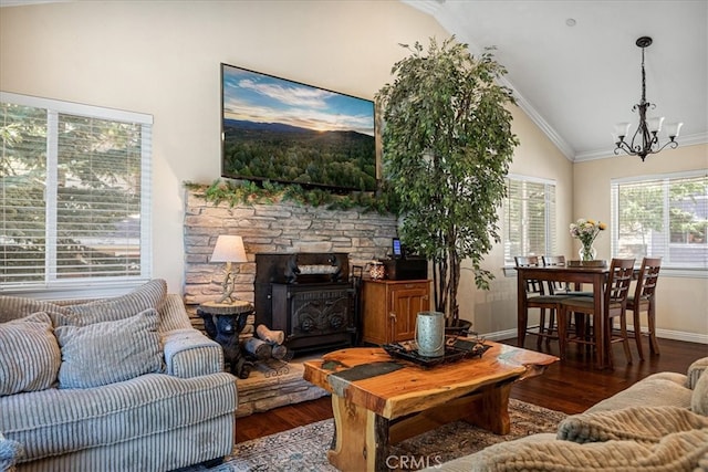 living room featuring crown molding, vaulted ceiling, dark hardwood / wood-style floors, and a wood stove