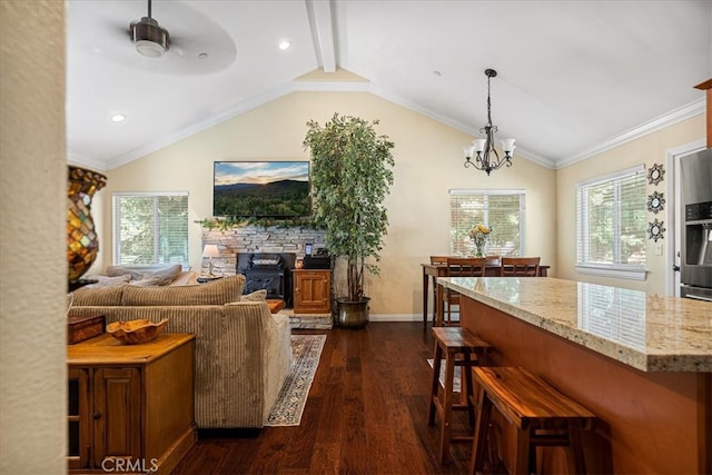 living room with ceiling fan with notable chandelier, lofted ceiling with beams, a fireplace, crown molding, and dark hardwood / wood-style flooring