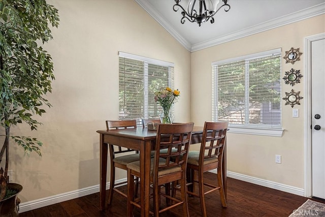 dining room with ornamental molding, lofted ceiling, a notable chandelier, and dark hardwood / wood-style flooring