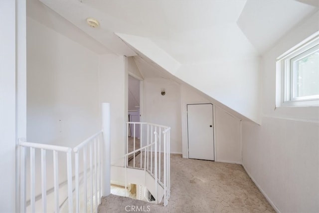 interior space featuring light carpet and lofted ceiling