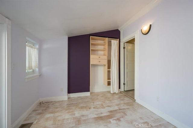 spare room with light hardwood / wood-style flooring and vaulted ceiling