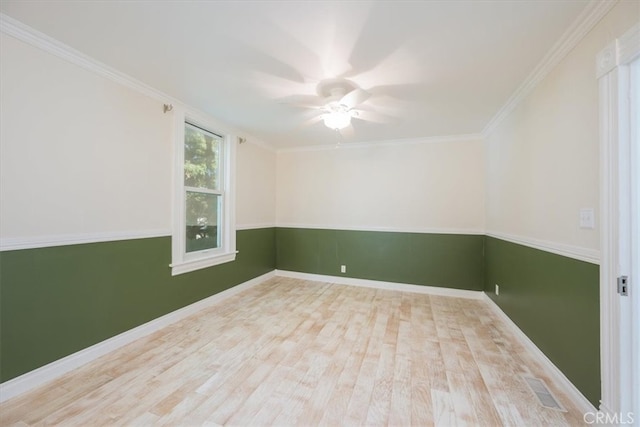 spare room with crown molding, light hardwood / wood-style floors, and ceiling fan