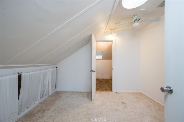 additional living space featuring light carpet, lofted ceiling, and ceiling fan