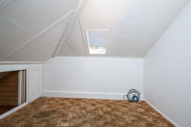 bonus room with lofted ceiling and carpet flooring