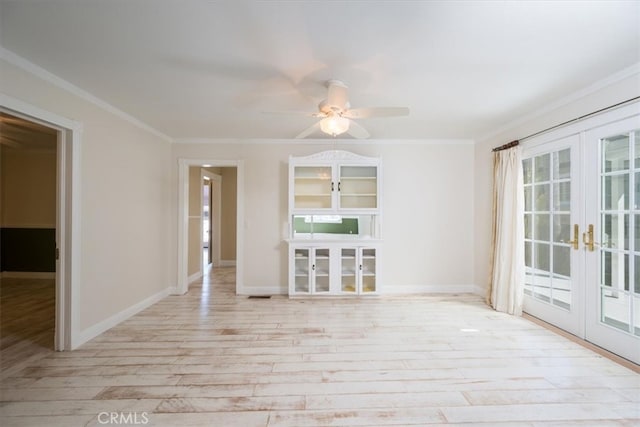 empty room with light hardwood / wood-style flooring, ceiling fan, french doors, and crown molding