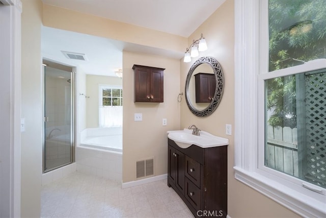 bathroom featuring plus walk in shower and vanity