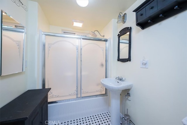 bathroom featuring shower / bath combination with glass door