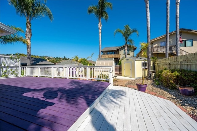 wooden deck with a storage shed