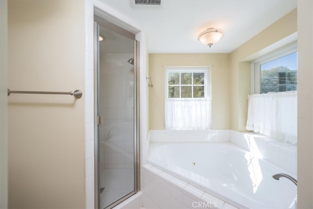 bathroom with shower with separate bathtub