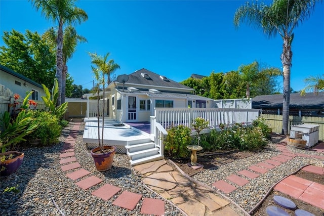 rear view of house with a wooden deck, a pergola, and a patio area