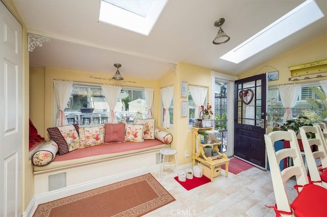 foyer entrance with vaulted ceiling with skylight