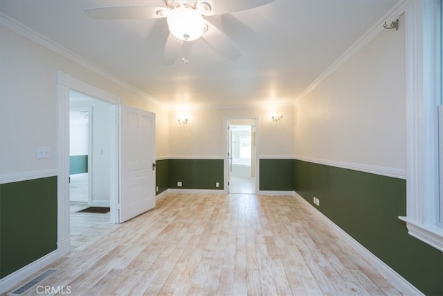 unfurnished room featuring light hardwood / wood-style floors, ceiling fan, and crown molding