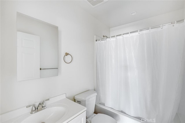 full bathroom with vanity, shower / tub combo, and toilet