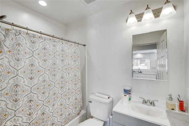 full bathroom featuring vanity, toilet, and shower / bathtub combination with curtain