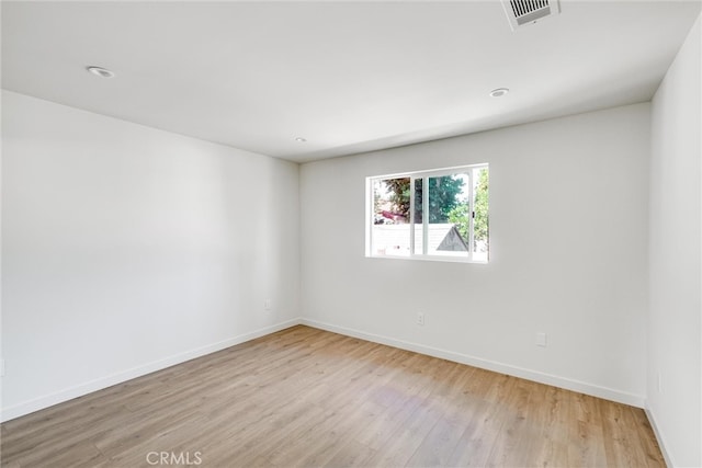 spare room featuring light hardwood / wood-style floors