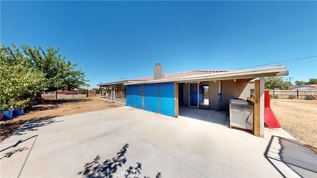 back of property with a patio