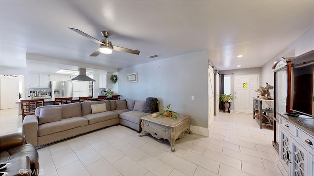 living room with light tile patterned floors and ceiling fan