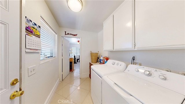 clothes washing area with cabinets, light tile patterned floors, and separate washer and dryer