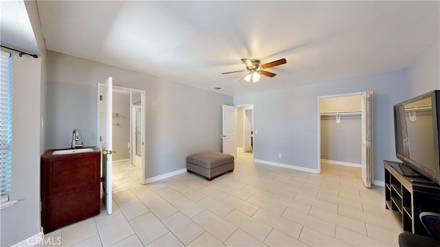 bedroom with a closet, ceiling fan, and sink