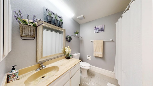 bathroom featuring tile patterned floors, vanity, and toilet