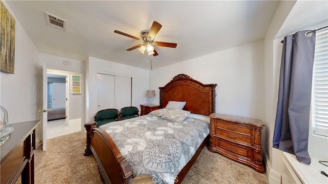 bedroom with light carpet, a closet, and ceiling fan