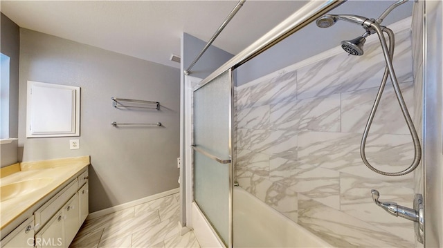 bathroom featuring vanity and combined bath / shower with glass door