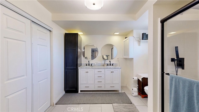 bathroom with vanity, a tile shower, and tile patterned floors