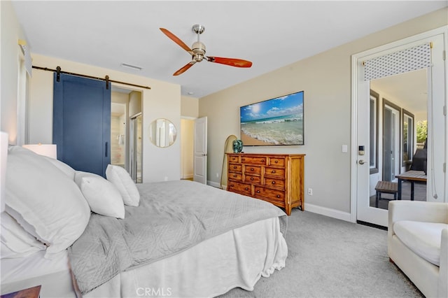 carpeted bedroom with ceiling fan, access to outside, and a barn door