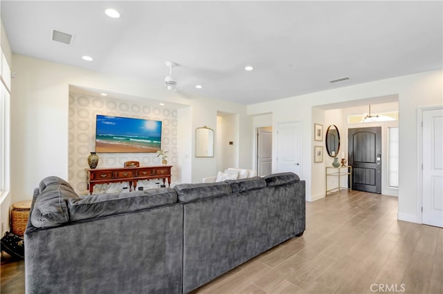 living room featuring ceiling fan and hardwood / wood-style floors