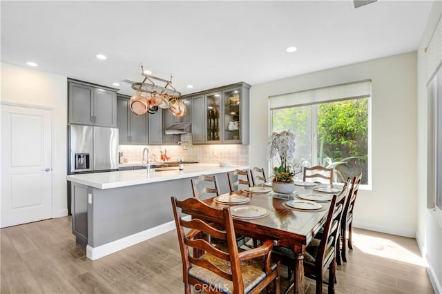 dining space featuring light hardwood / wood-style floors and sink