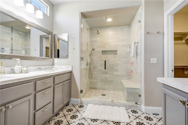 bathroom with vanity, a shower with shower door, and tile patterned flooring